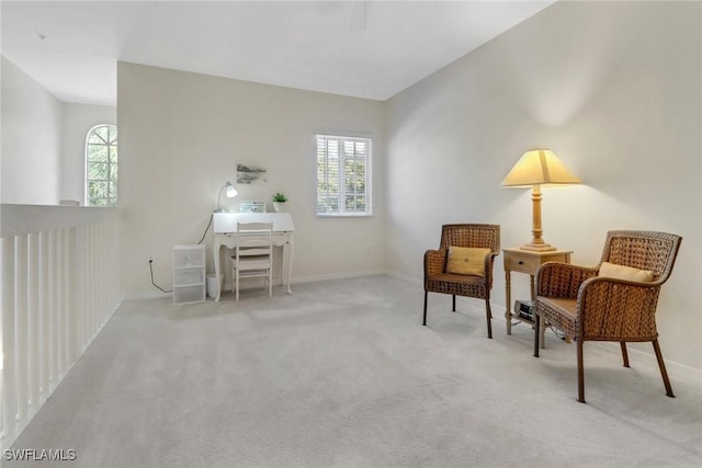 sitting room with a healthy amount of sunlight and light carpet