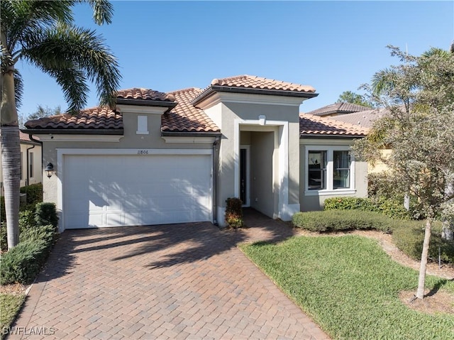 mediterranean / spanish home with a garage