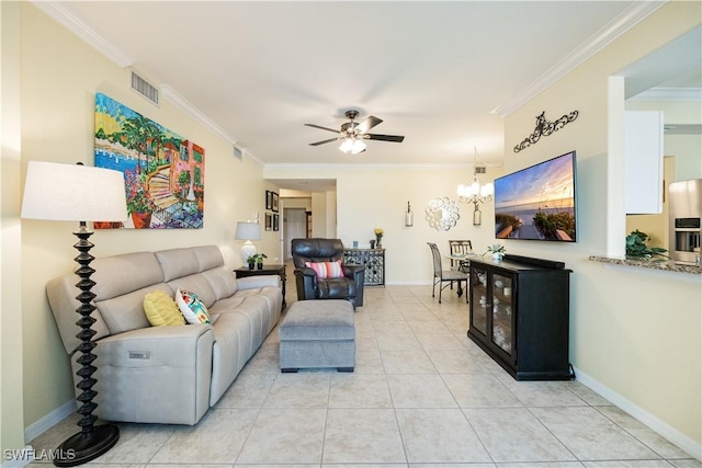 living room featuring crown molding, visible vents, light tile patterned flooring, baseboards, and ceiling fan with notable chandelier