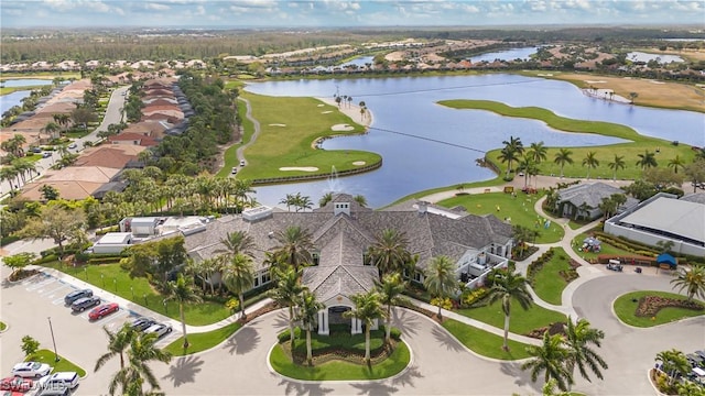 bird's eye view featuring a water view, view of golf course, and a residential view