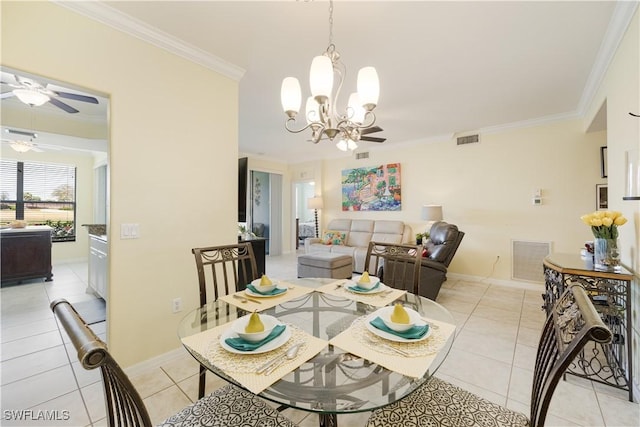 dining room with light tile patterned floors, visible vents, and crown molding