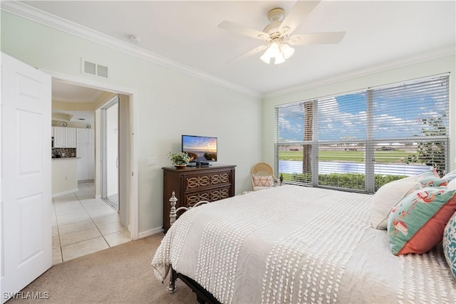 bedroom with light colored carpet, visible vents, crown molding, and light tile patterned floors