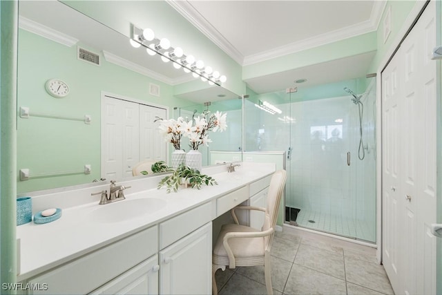 bathroom featuring visible vents, tile patterned flooring, crown molding, a shower stall, and a sink