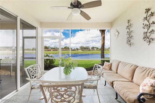 sunroom / solarium with a water view and a ceiling fan