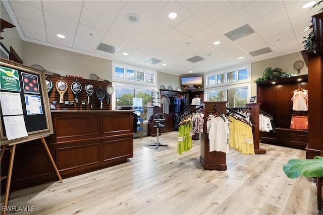 misc room with light wood-style floors, ornamental molding, a drop ceiling, and recessed lighting