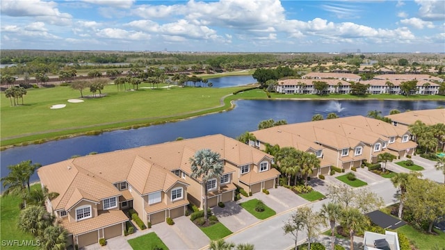 drone / aerial view featuring a water view and a residential view