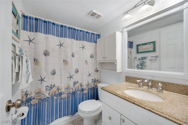 bathroom featuring vanity, walk in shower, and toilet