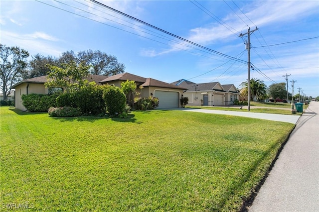 ranch-style home with a front lawn, driveway, an attached garage, and stucco siding