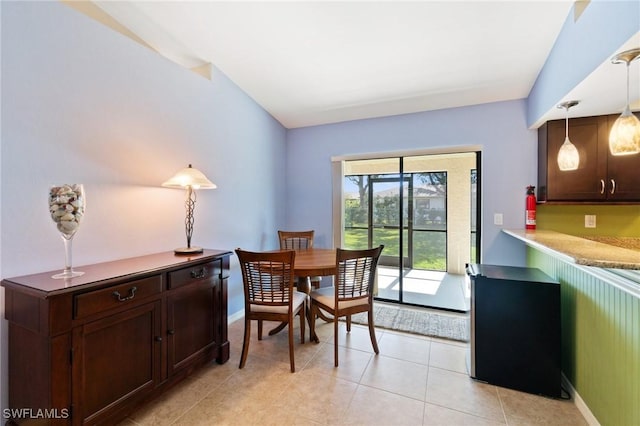 dining room featuring light tile patterned floors and baseboards