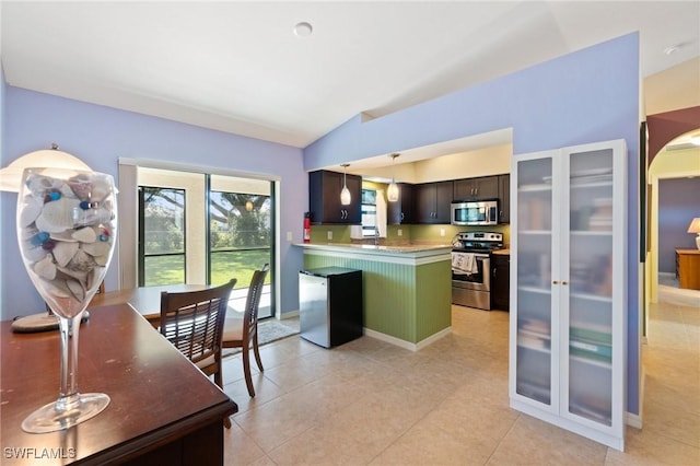 kitchen with vaulted ceiling, pendant lighting, dark brown cabinetry, green cabinetry, and stainless steel appliances