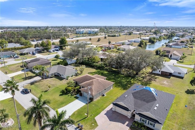 bird's eye view featuring a water view and a residential view