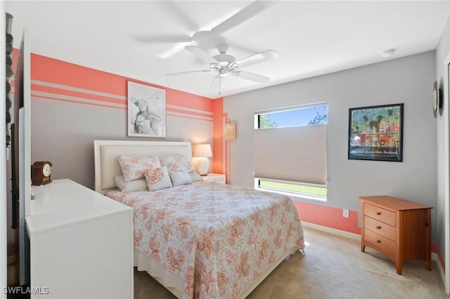 bedroom featuring light carpet, ceiling fan, and baseboards