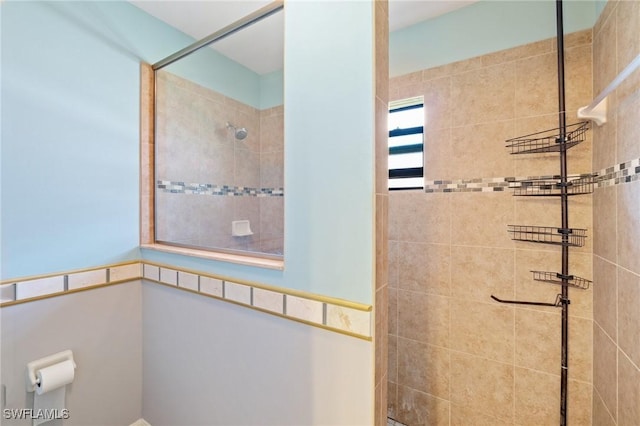 bathroom with tiled shower