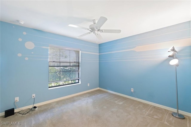 spare room featuring baseboards, a ceiling fan, and carpet flooring