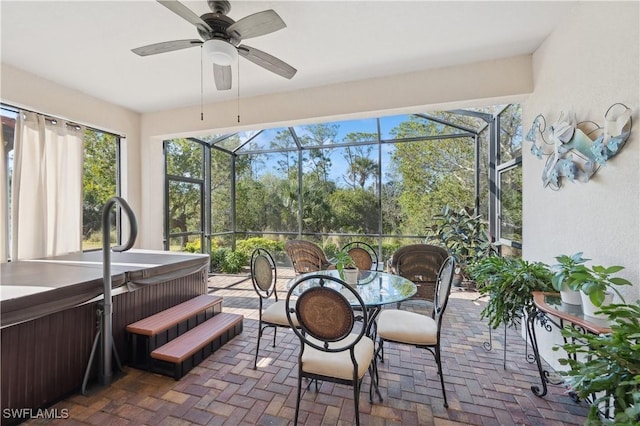 sunroom / solarium featuring ceiling fan