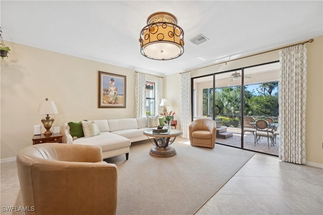 living room with ceiling fan and light tile patterned floors