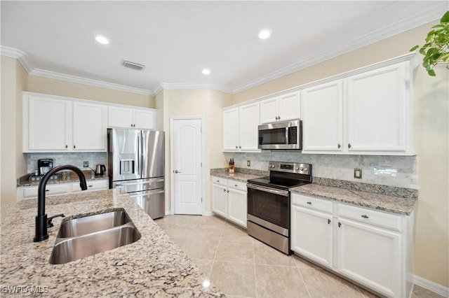 kitchen featuring white cabinetry, sink, stainless steel appliances, and light stone countertops