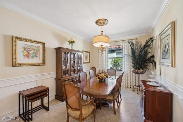 tiled dining area featuring ornamental molding