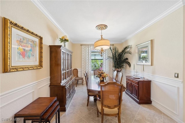 dining area featuring crown molding and light tile patterned floors