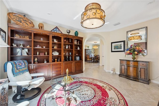 living area featuring ornamental molding and light tile patterned floors