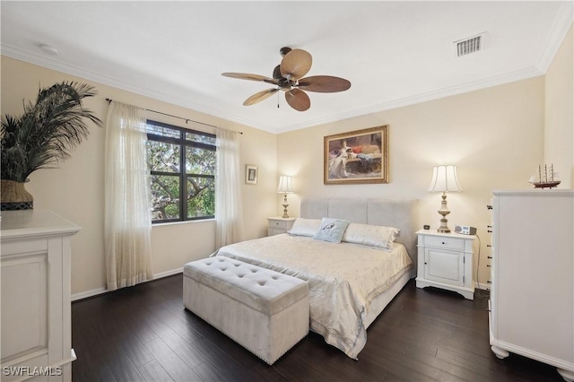 bedroom with ornamental molding, dark hardwood / wood-style floors, and ceiling fan