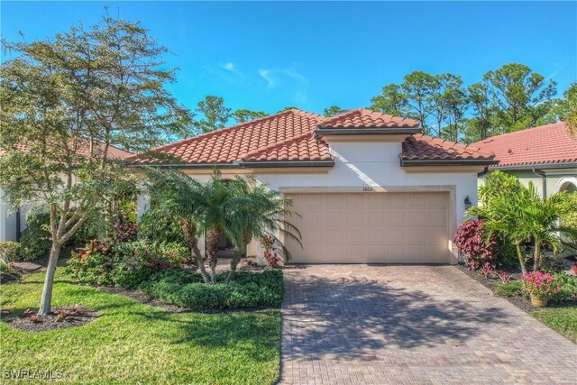 mediterranean / spanish-style home with a garage