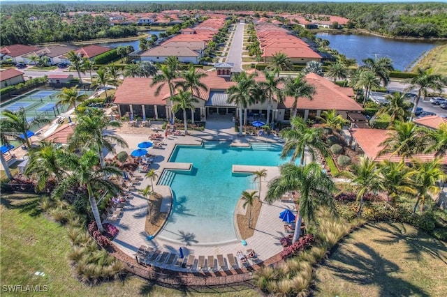 view of swimming pool with a water view and a patio area