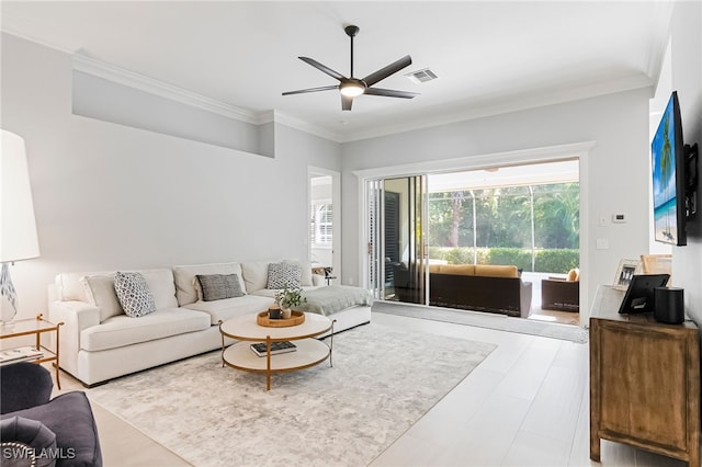 living room featuring ornamental molding and ceiling fan