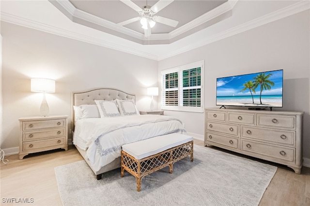 bedroom with a raised ceiling, ornamental molding, light wood-type flooring, and ceiling fan