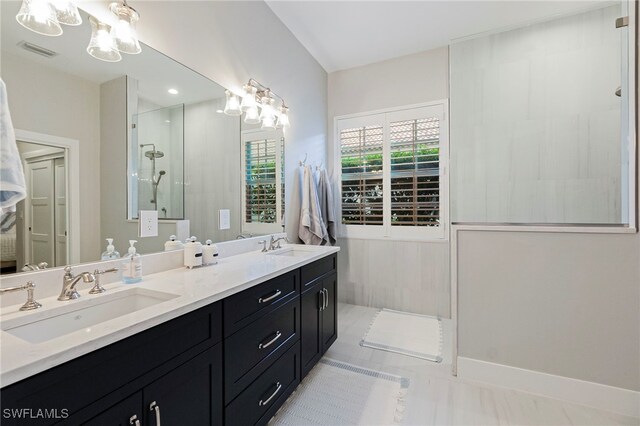 bathroom featuring tile patterned flooring, vanity, and a shower with door