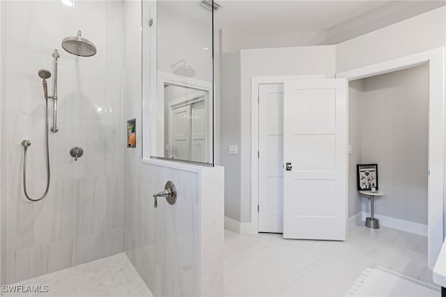 bathroom with tiled shower