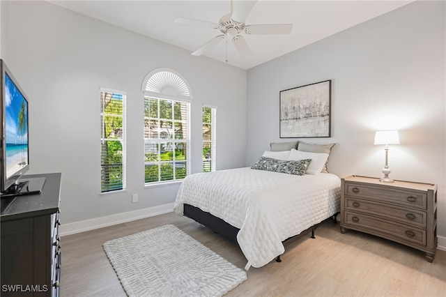 bedroom with ceiling fan and light hardwood / wood-style floors