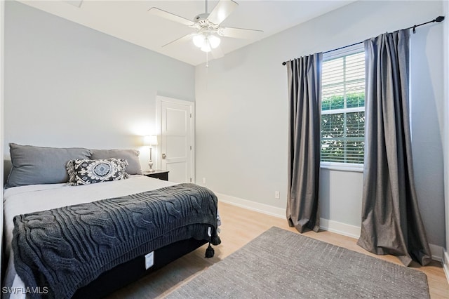 bedroom with ceiling fan and light hardwood / wood-style flooring