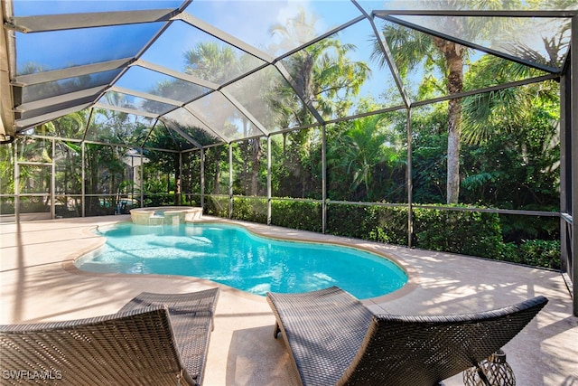 view of swimming pool with an in ground hot tub, a patio area, and glass enclosure