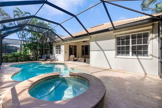 view of swimming pool with an in ground hot tub, ceiling fan, glass enclosure, and a patio area