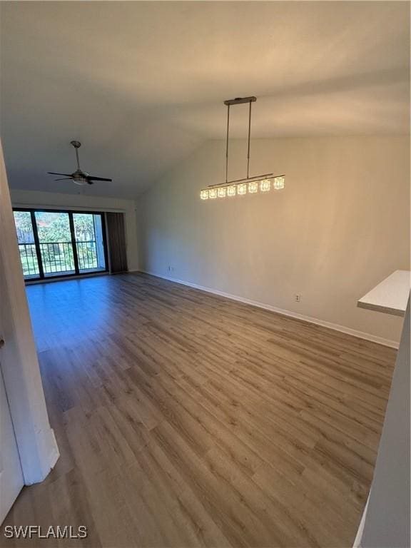 interior space with hardwood / wood-style floors, vaulted ceiling, and ceiling fan