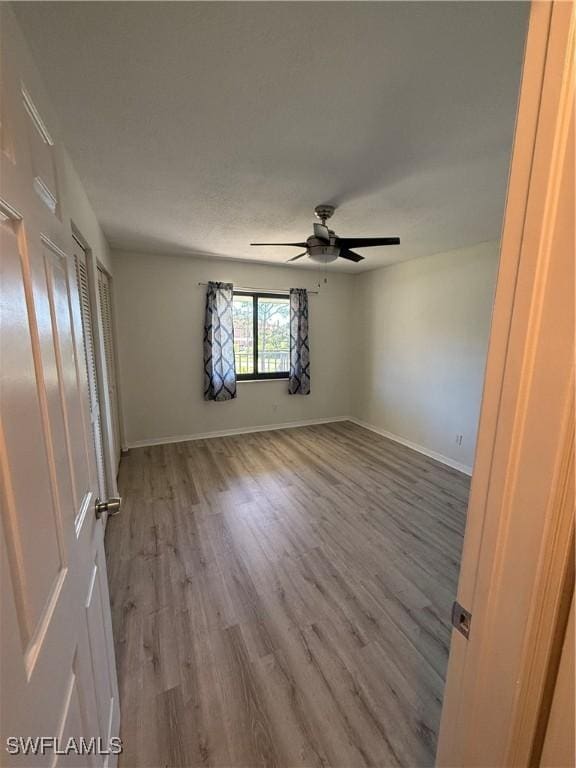 unfurnished room with hardwood / wood-style floors and ceiling fan