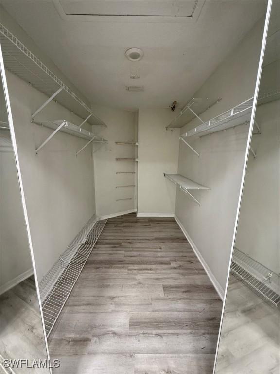 walk in closet featuring hardwood / wood-style floors