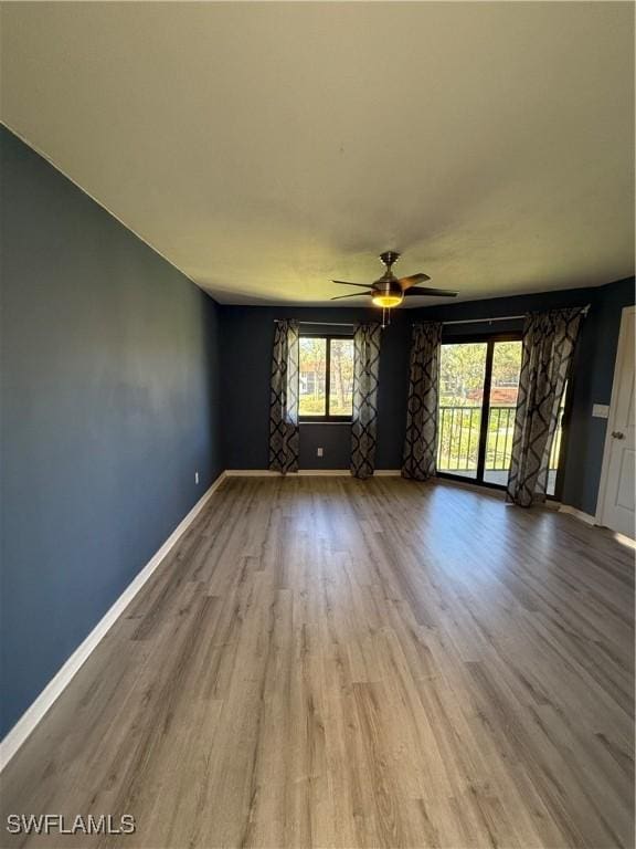 unfurnished room featuring light hardwood / wood-style flooring and ceiling fan