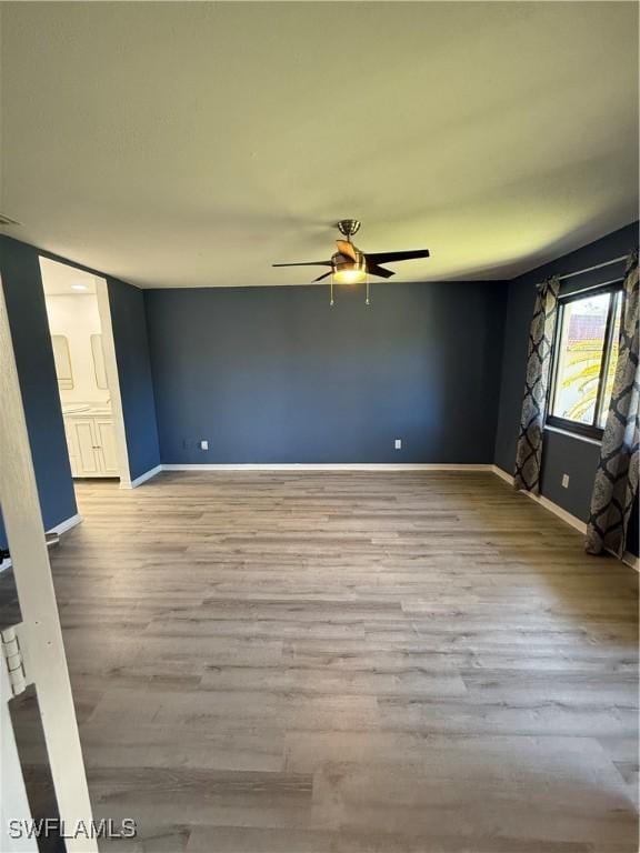 empty room featuring ceiling fan and light wood-type flooring