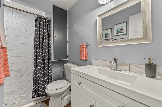 bathroom featuring vanity, a shower with shower curtain, and toilet