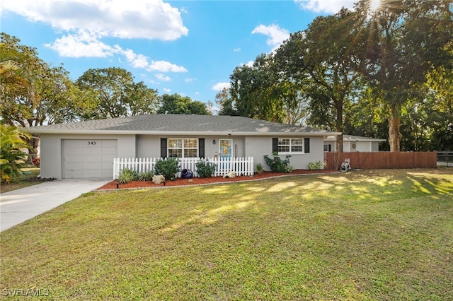 ranch-style house featuring a garage and a front yard