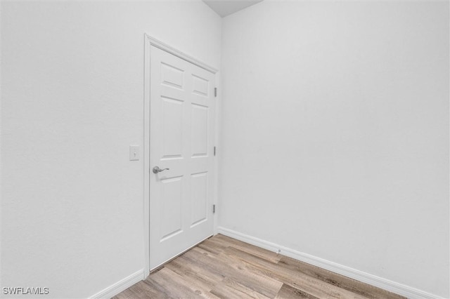 unfurnished room featuring light wood-type flooring and baseboards