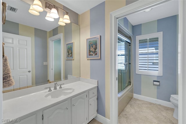 full bathroom featuring enclosed tub / shower combo, vanity, toilet, and tile patterned flooring