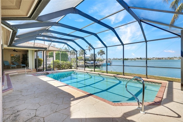 view of pool with a water view, a patio, a lanai, and ceiling fan