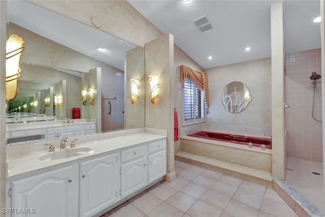 bathroom featuring tile patterned flooring, vanity, vaulted ceiling, and shower with separate bathtub