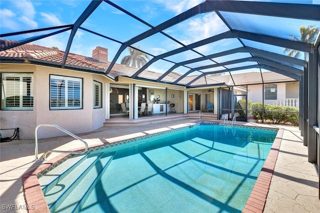 view of swimming pool with a lanai and a patio area