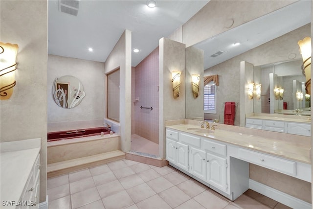 bathroom with tile patterned flooring, shower with separate bathtub, and vanity