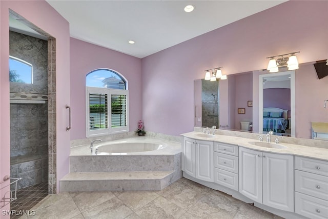 full bathroom featuring vanity, shower with separate bathtub, and toilet