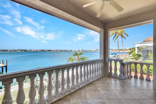 balcony with a water view and ceiling fan